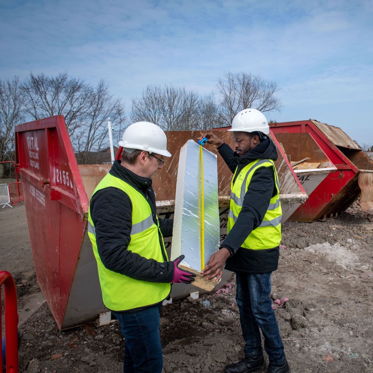 Two men inspecting rubbish